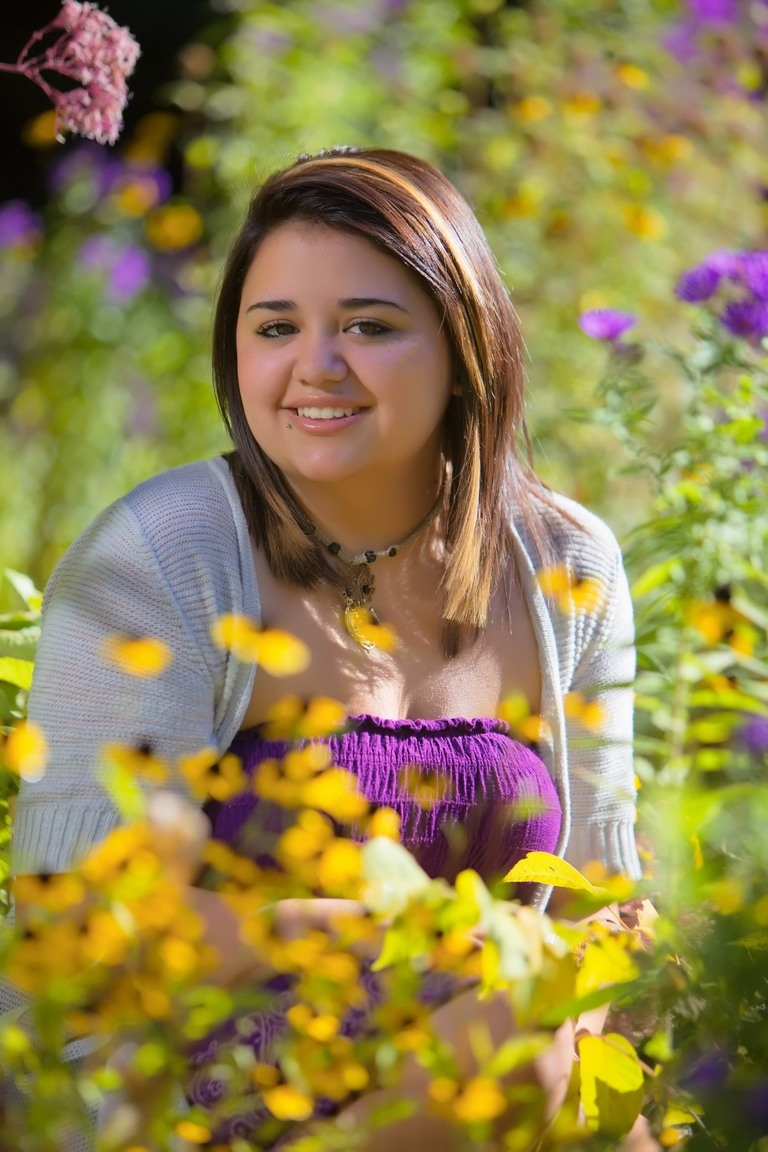 Senior portrait framed by yellow flowers
