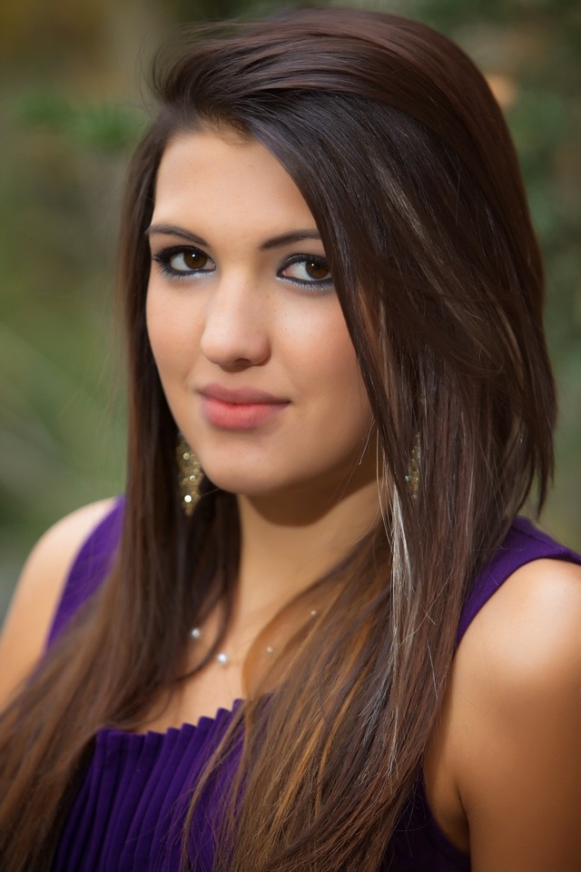 Close-up senior portrait of a student in a purple top