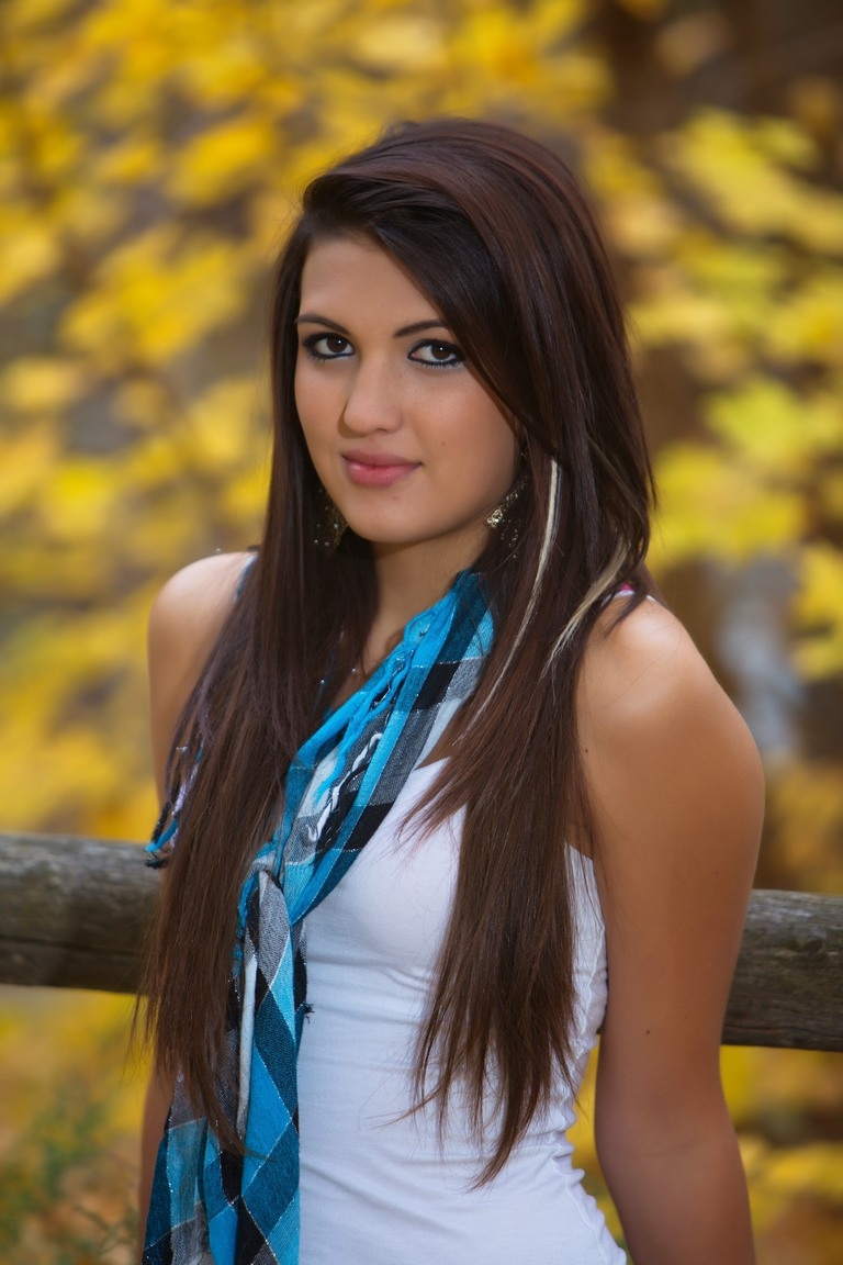 Senior portrait of a student wearing a blue scarf outdoors
