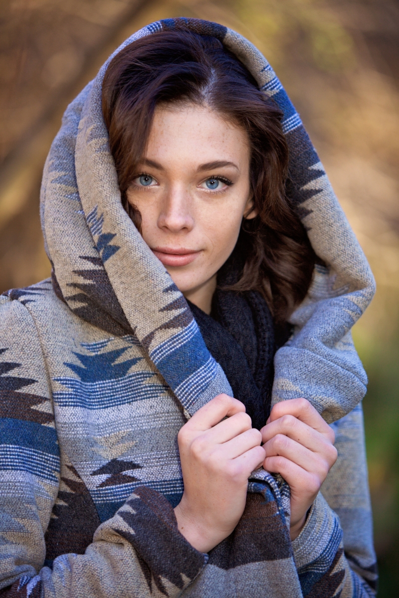 Close-up senior portrait with a hooded jacket