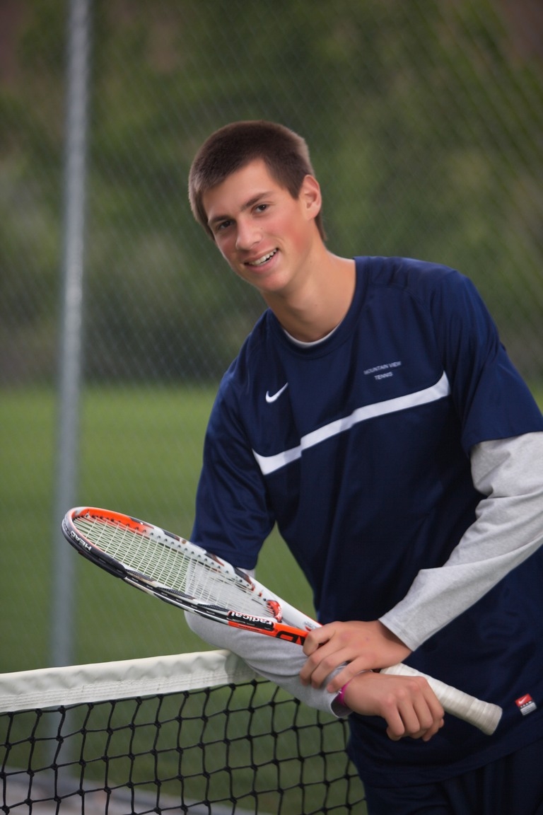 Senior portrait of a student holding a tennis racket