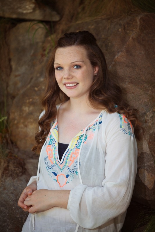 Senior portrait with a floral top and light cardigan